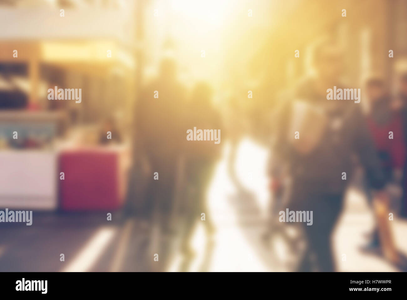 Crowd of people on the street, blur defocussed image of general public with unrecognizable men and women in urban district Stock Photo