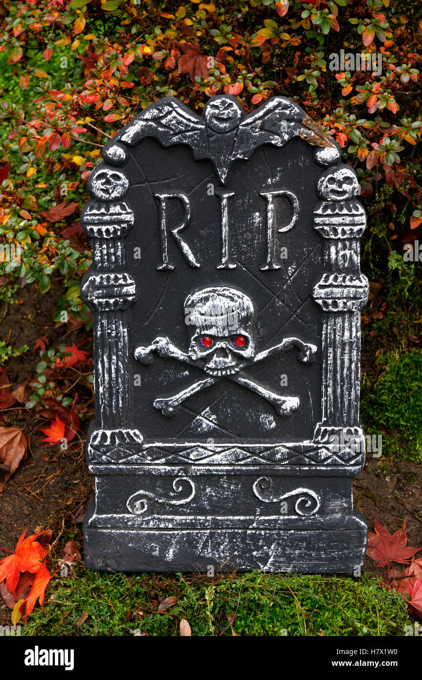 Halloween tombstone decorated with skulls and rest in peace RIP lettering, Vancouver, BC, Canada Stock Photo