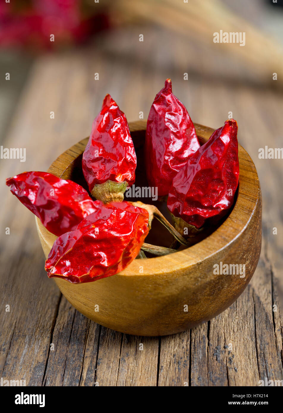 Bunch of red hot chili pepper on wooden table Stock Photo - Alamy