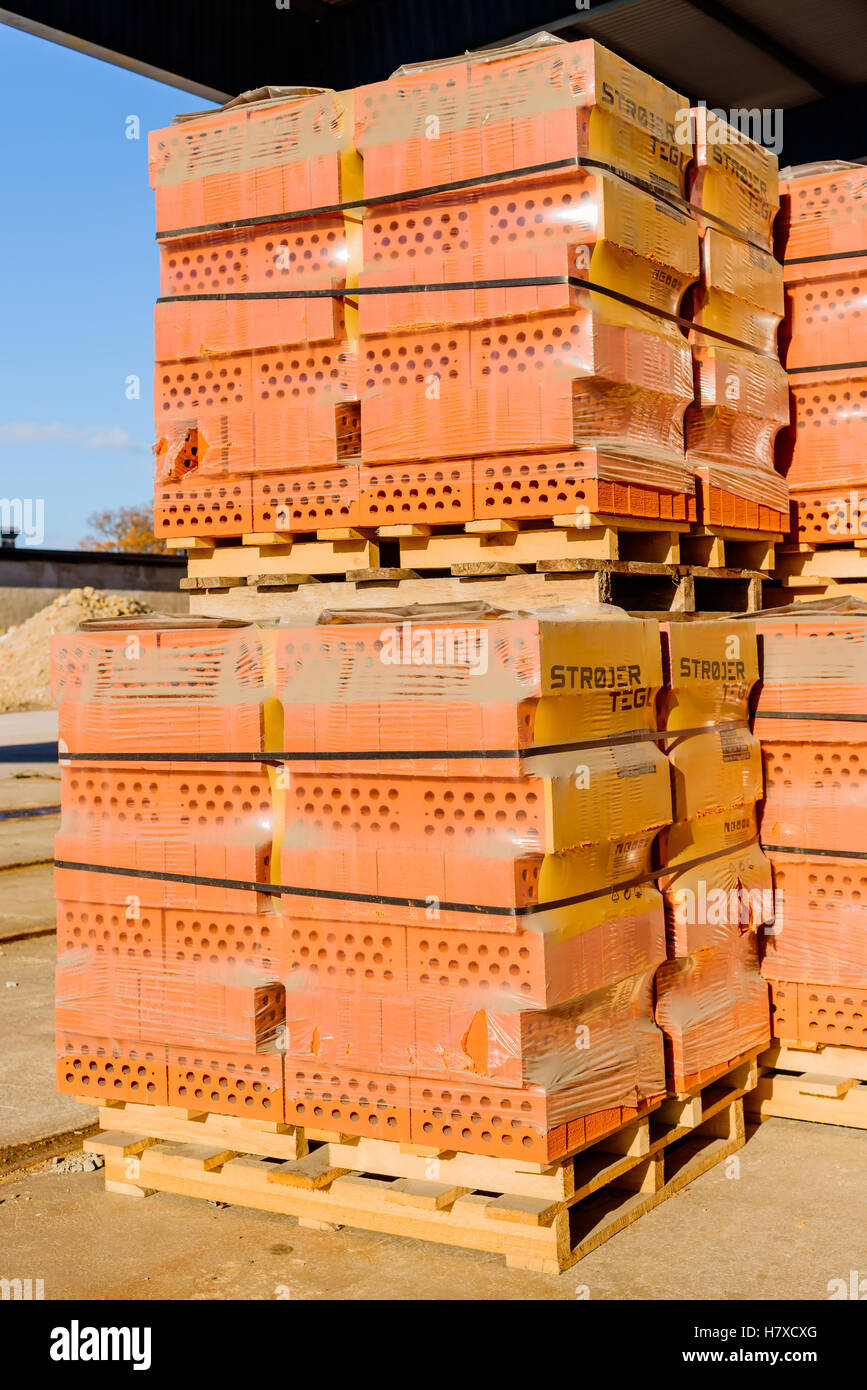 Brakne Hoby, Sweden - October 29, 2016: Documentary of industrial area. Plastic wrapped red bricks with holes ready for transpor Stock Photo