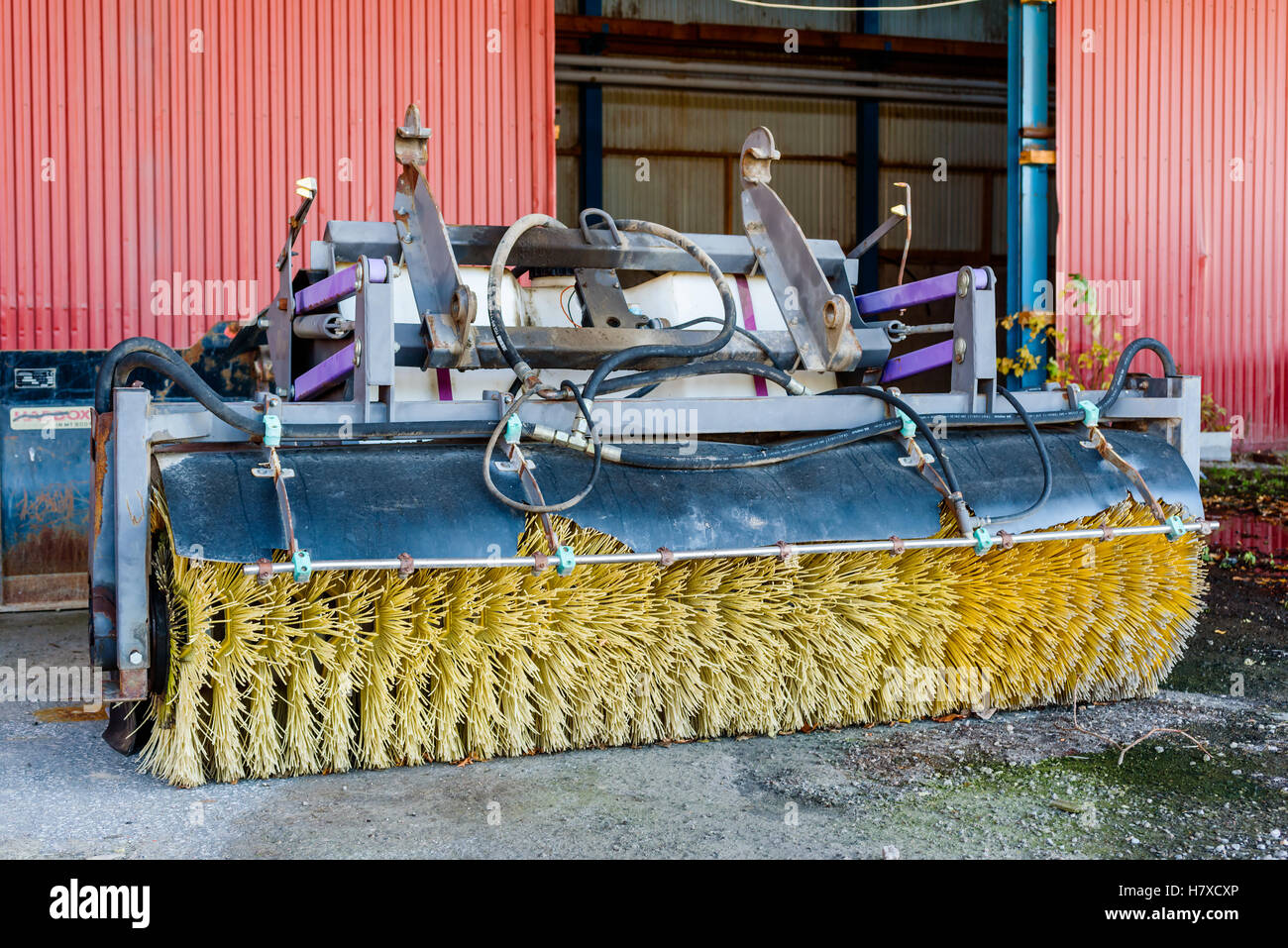 Brakne Hoby, Sweden - October 29, 2016: Documentary of public industrial area. Rotating road broom stored outside an open buildi Stock Photo
