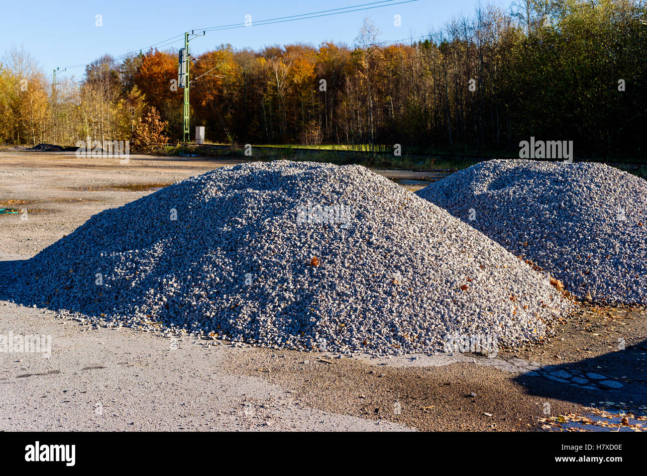 Pile of gravel with railroad tracks in background Stock Photo