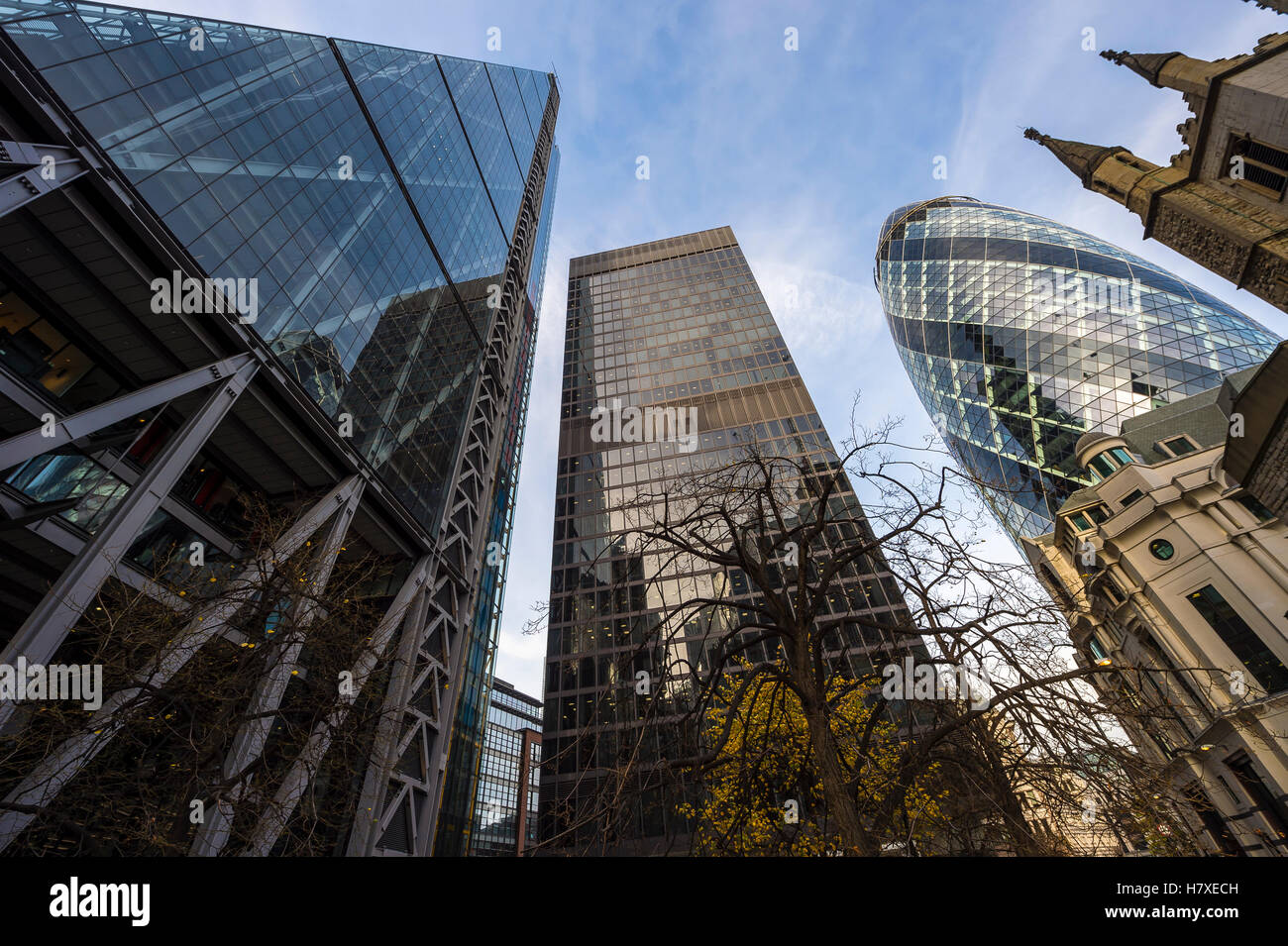 LONDON - NOVEMBER 3, 2016: The Cheesegrater and The Gherkin skyscrapers stand above the 16th century St Andrew Undershaft church Stock Photo