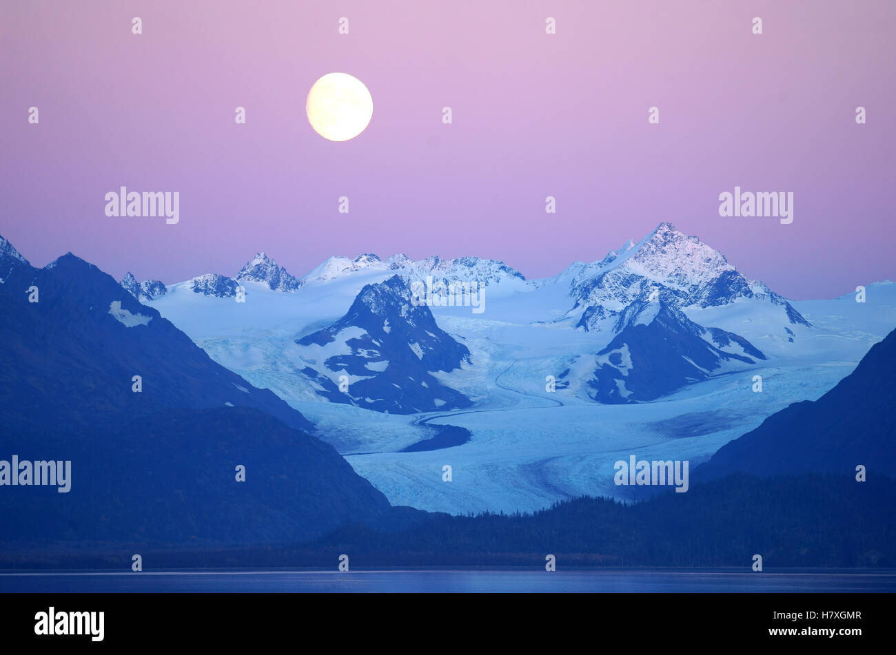 Moon rising over Grewingk glacier, Kenai mountains on Kachemak Bay, Alaska Stock Photo