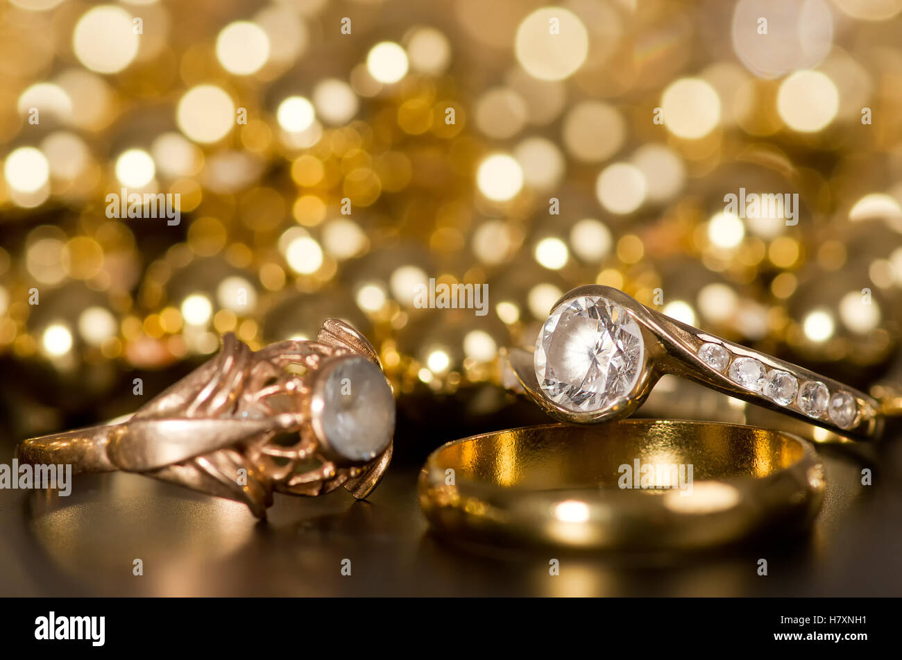 Gold jewelry on a black background. In the back of the golden light Stock  Photo - Alamy