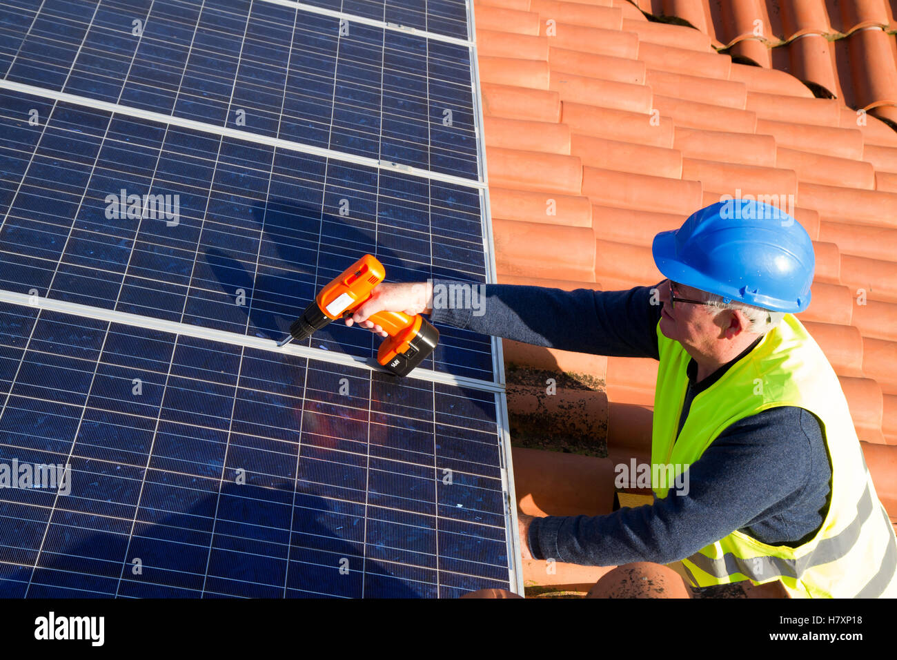 skilled worker working on a photovoltaic plant Stock Photo