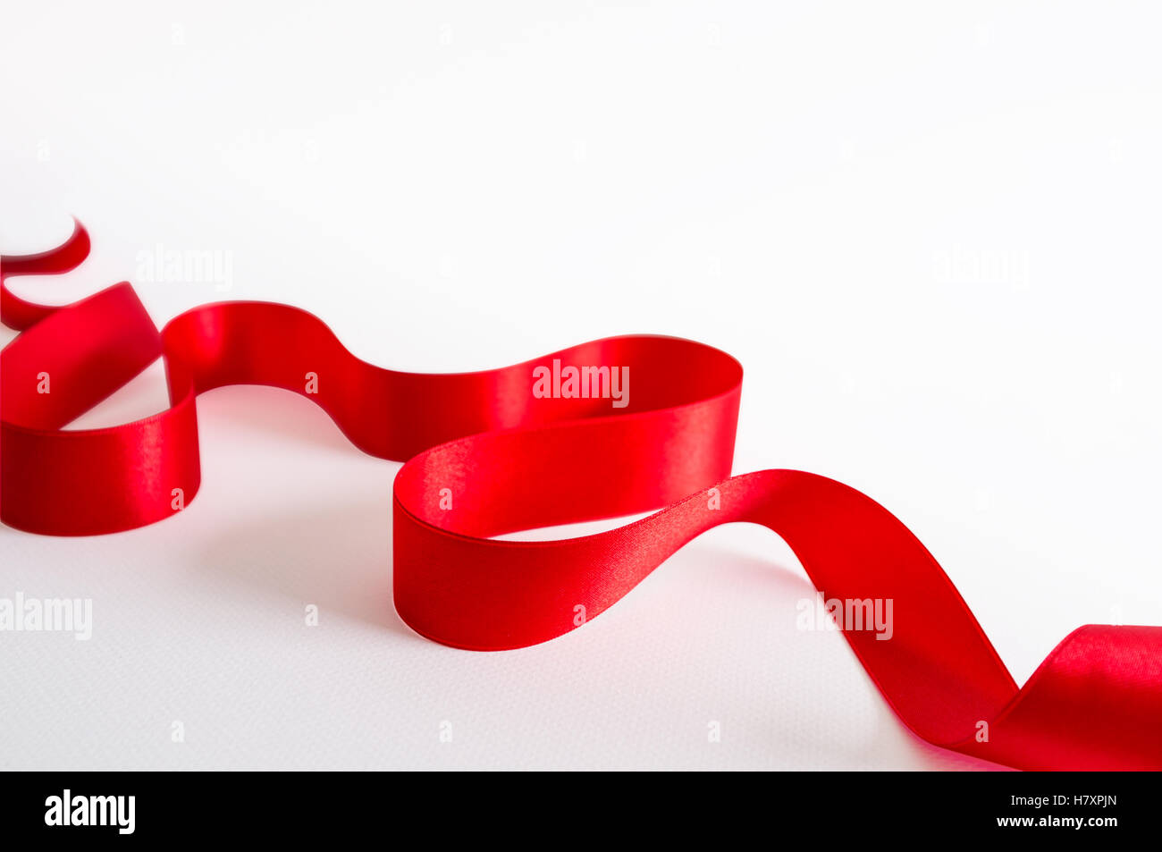 Red satin ribbon isolated on white background Stock Photo - Alamy