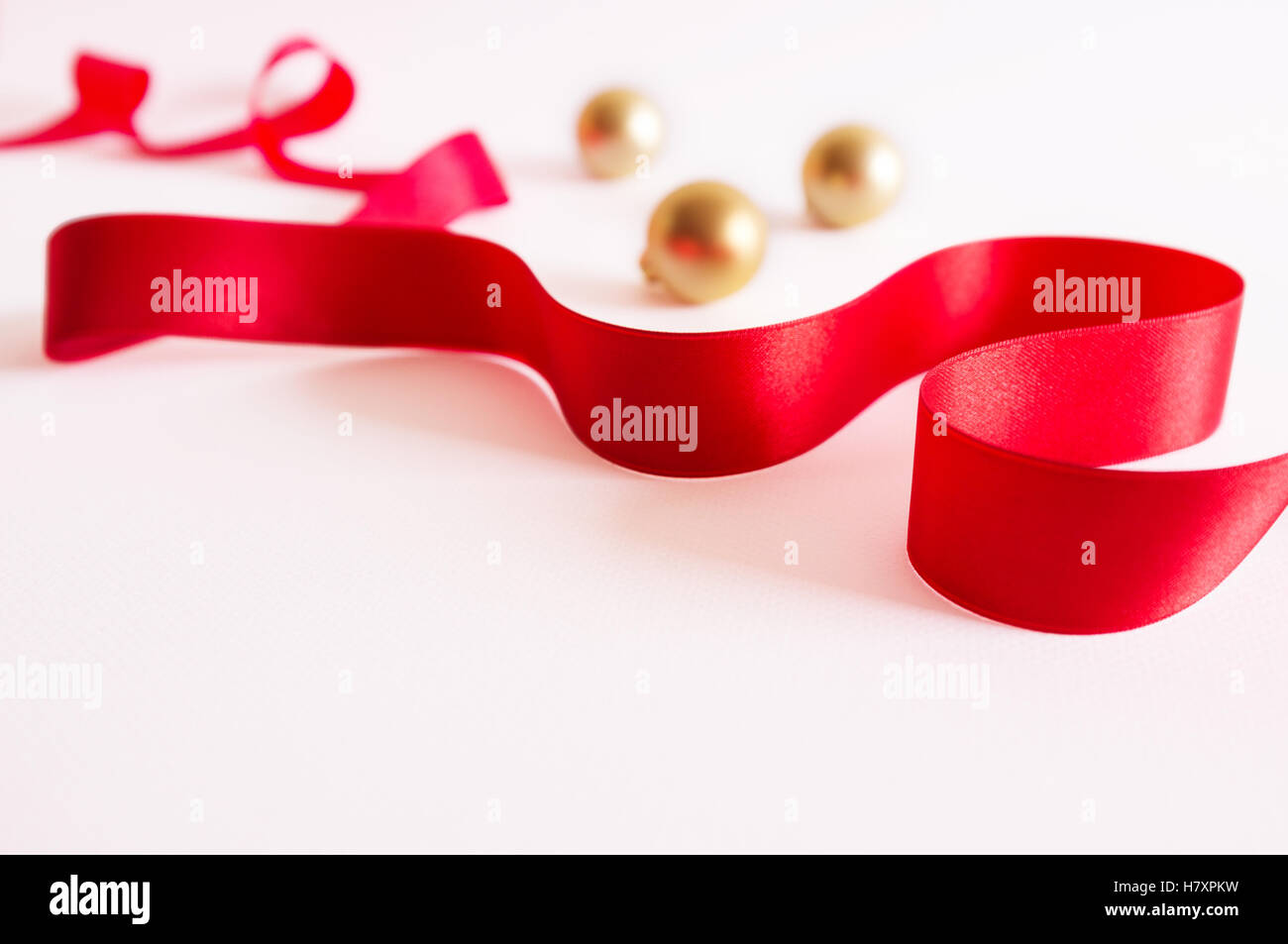 Golden christmas balls with red ribbon on white background Stock Photo ...