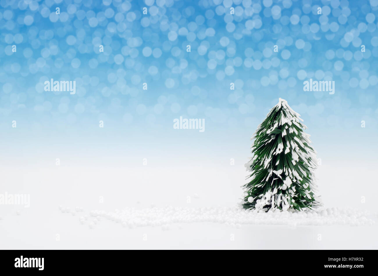 Christmas tree with lights snow winter background. Christmas holiday celebration concept. Stock Photo