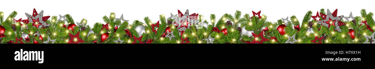 christmas garland super wide panorama banner with fir branches red silver stars lights and baubles xmas decoration isolated on w Stock Photo