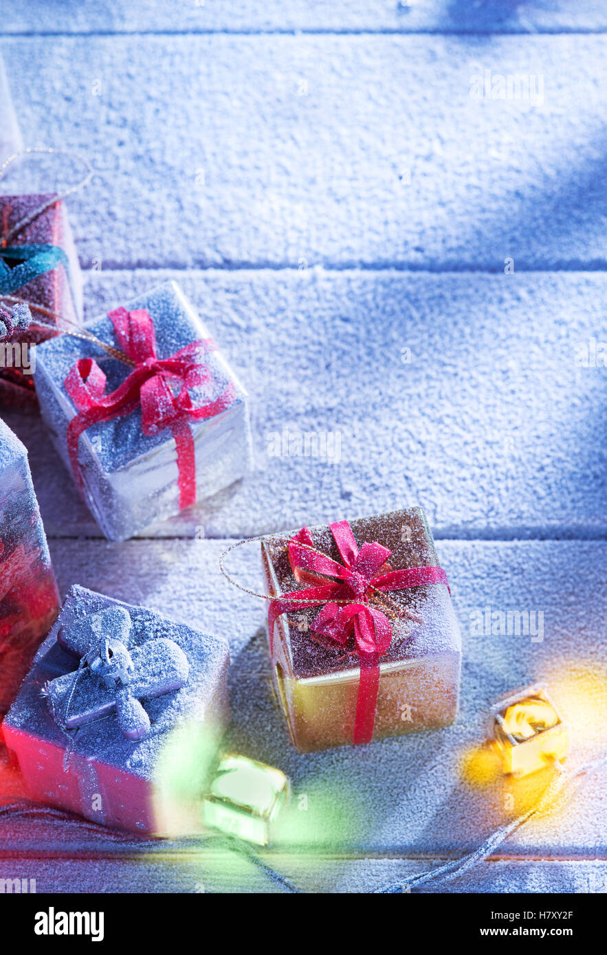 close up view  of gifts boxes  on snowbound  wooden back Stock Photo