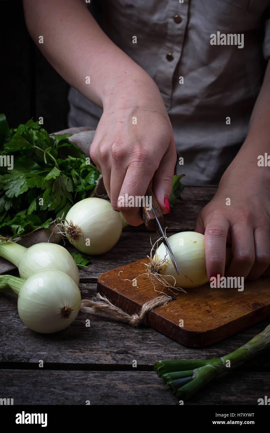 Woman hands cut onion. Selective focus Stock Photo - Alamy