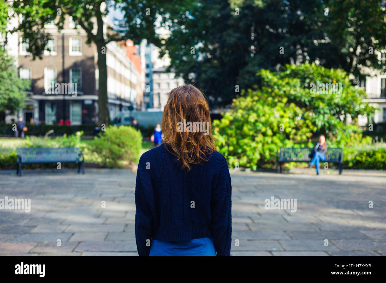 A young woman is standing in a park on a summer day Stock Photo - Alamy