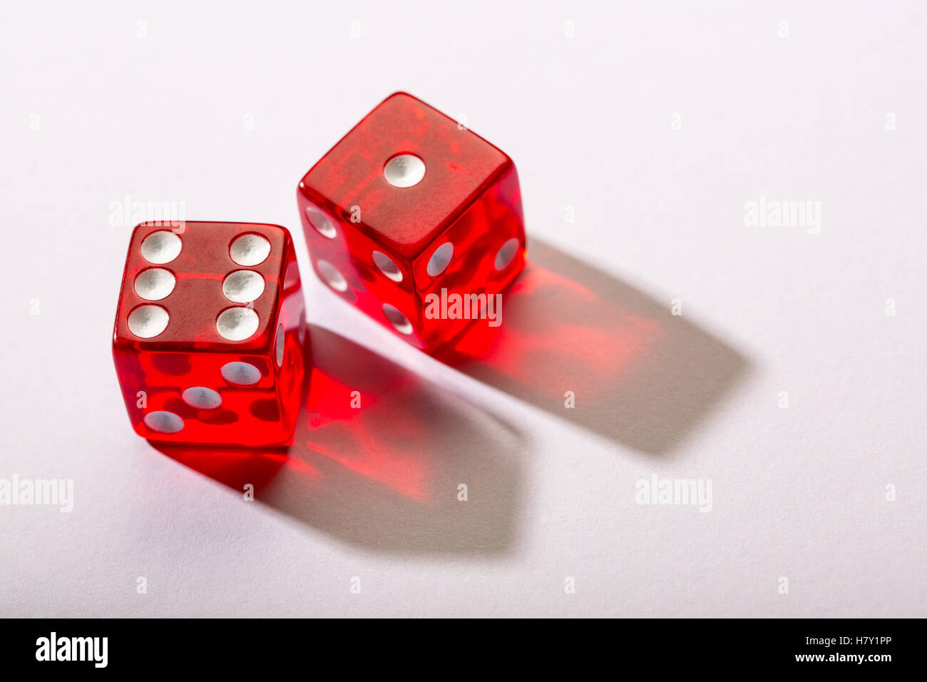 red dice against a white background Stock Photo
