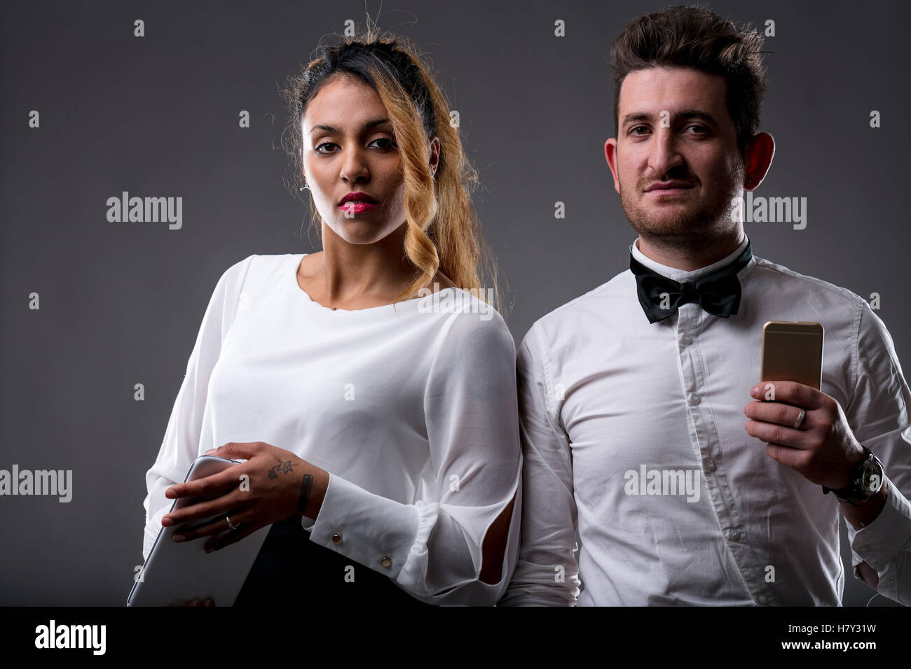 upperclass woman and man with their digital devices ready to have business using internet and apps Stock Photo