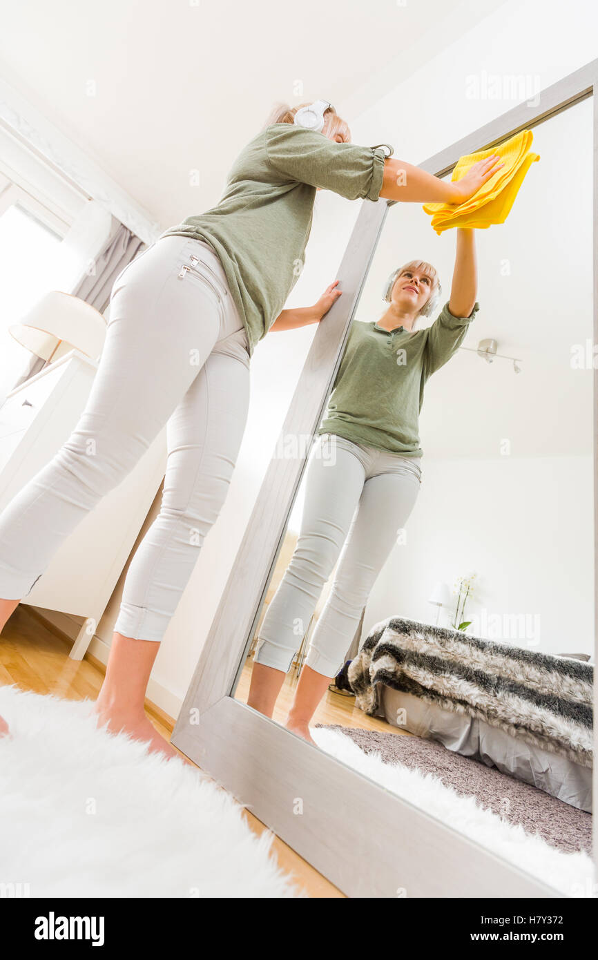 Young woman makes cleaning listening music Stock Photo Alamy