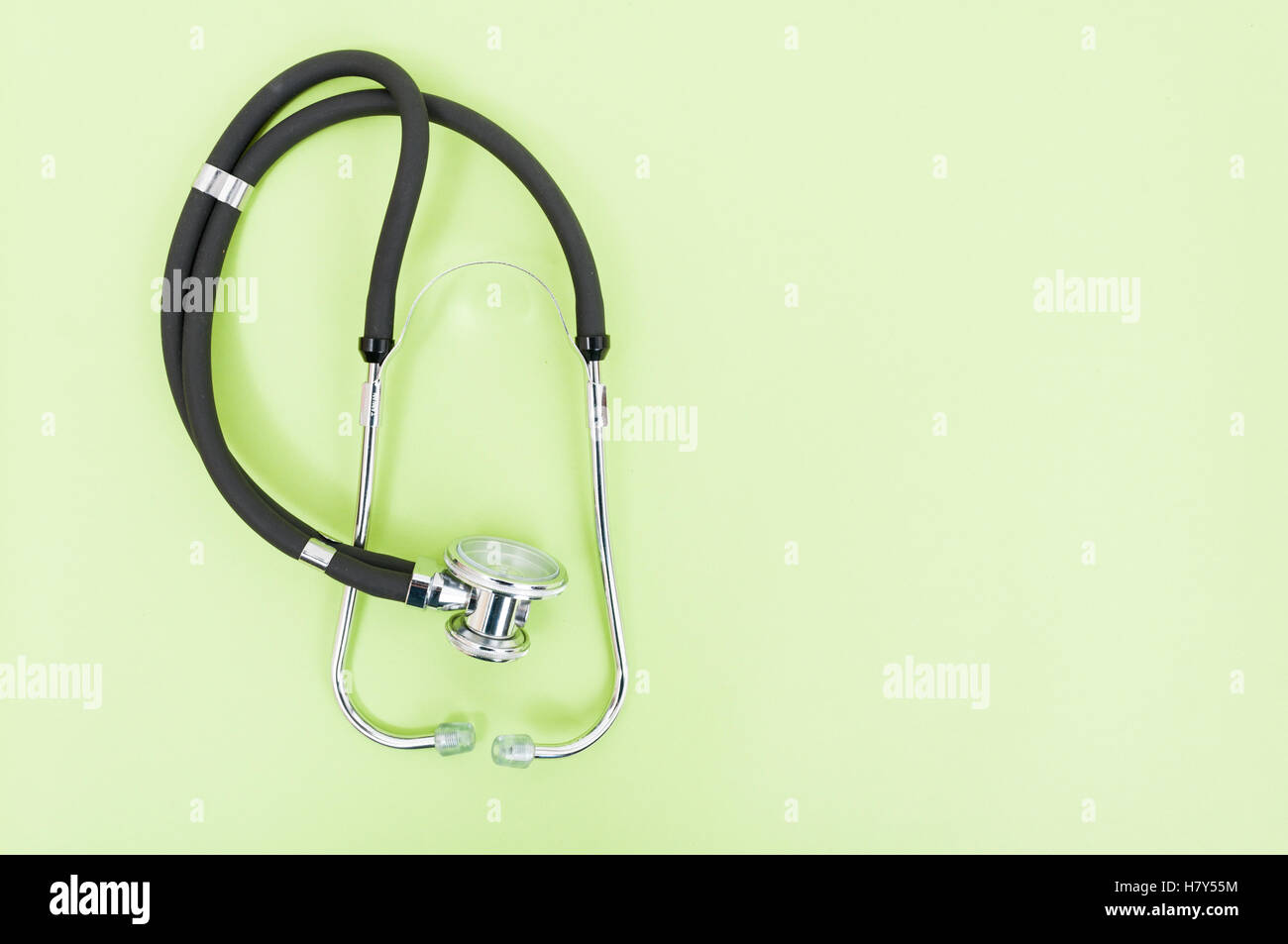 Copyspace image with stethoscope on green background with text area as ...