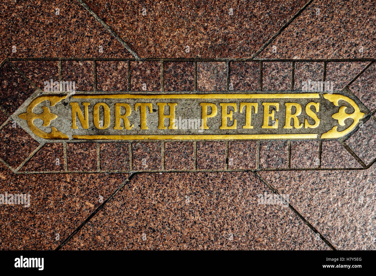 Street Sign In Pavement labeled North Peters. Stock Photo