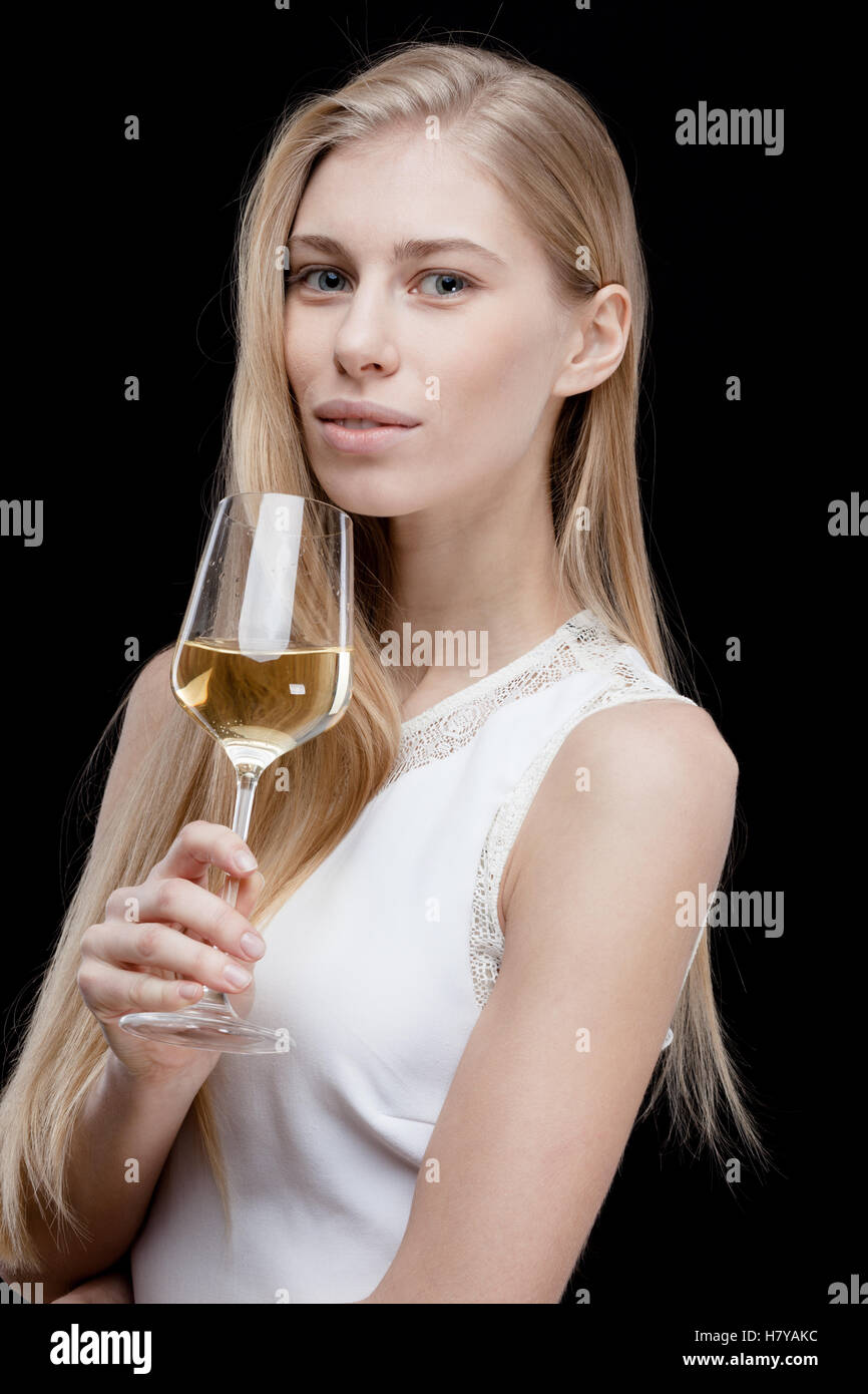 young blond woman holding glass of white wine Stock Photo - Alamy
