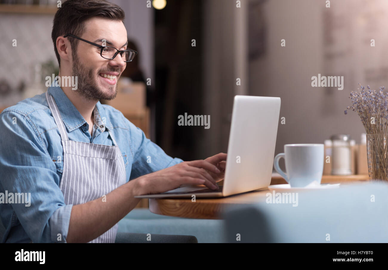 smiling happy man working on laptop Stock Photo - Alamy