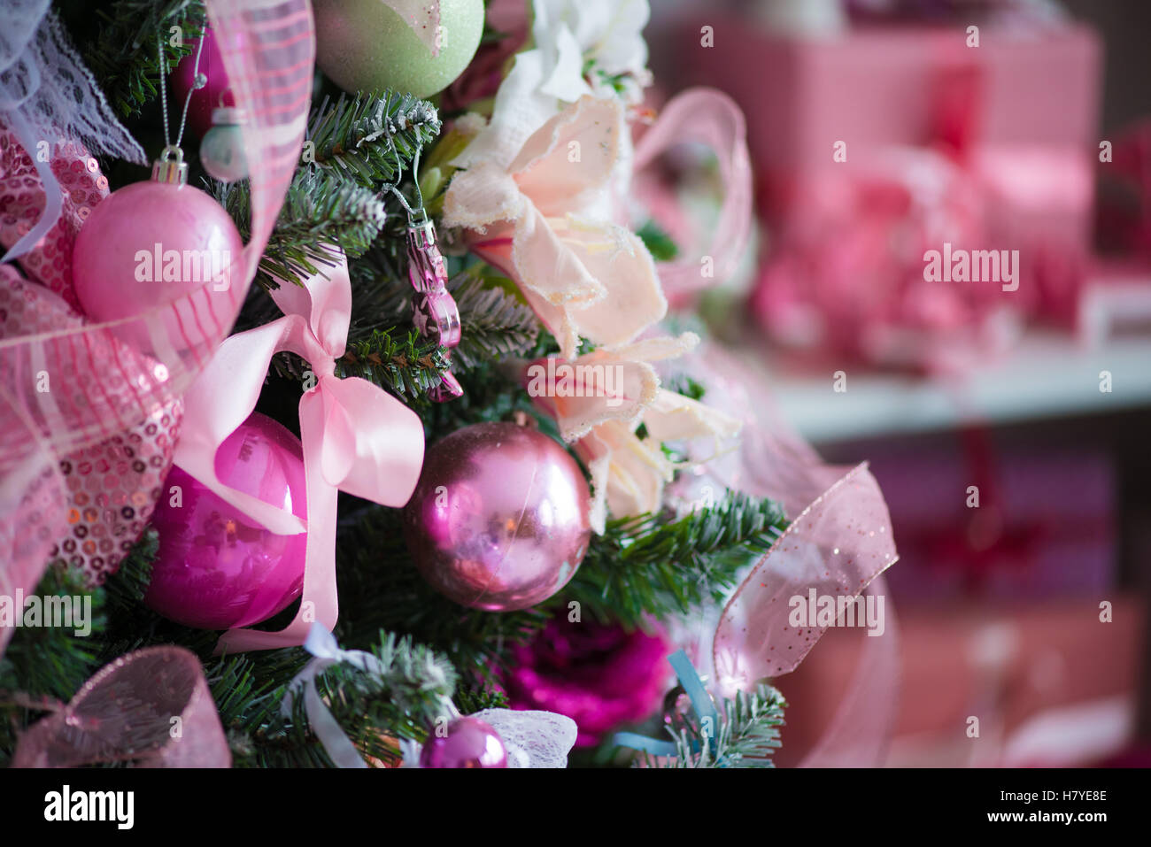 A Christmas tree fully festooned with Christmas decorations. In the