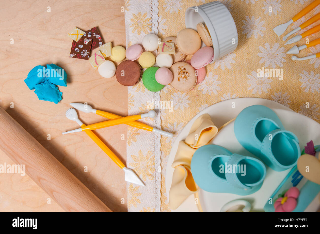 A view from the top of bisquits, tools and ingredients for cake design. Stock Photo