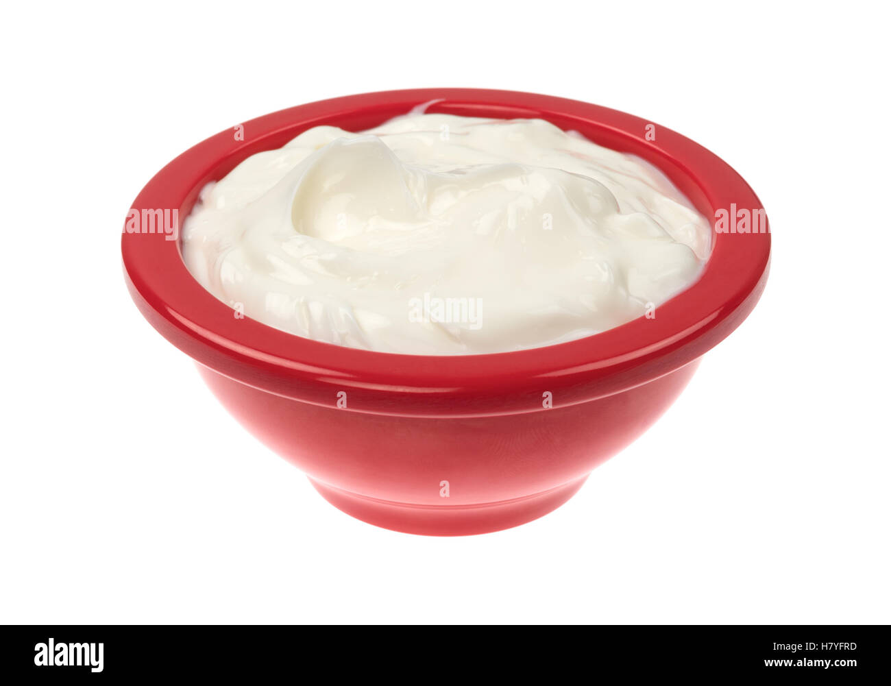 A red bowl filled with cocoa butter cream skin lotion isolated on a white background. Stock Photo