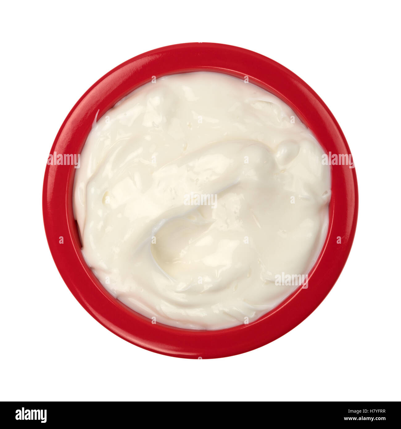 Top view of a red bowl filled with cocoa butter cream skin lotion isolated on a white background. Stock Photo