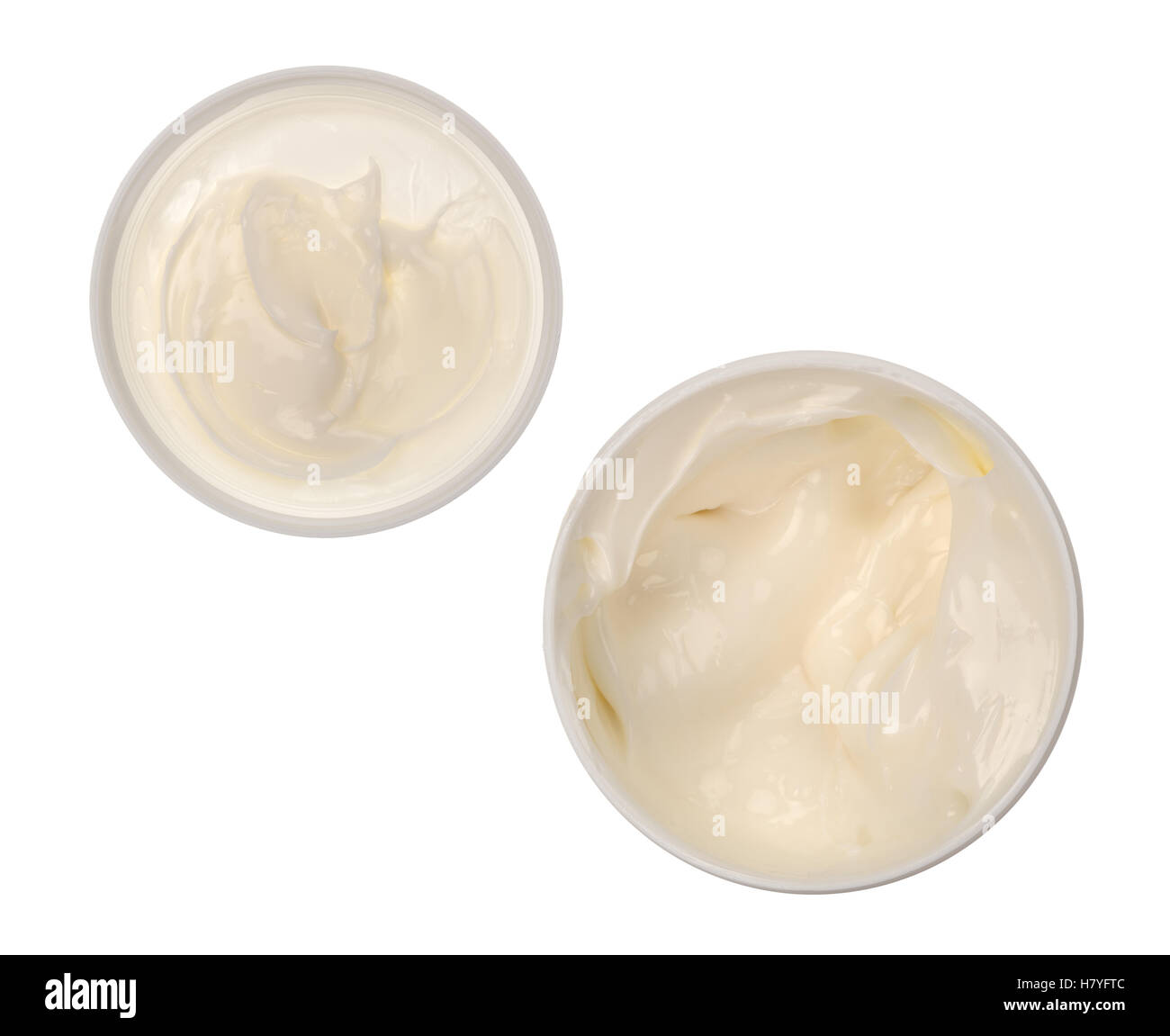 Top view of a container of cocoa butter cream skin lotion with the lid to the side isolated on a white background. Stock Photo