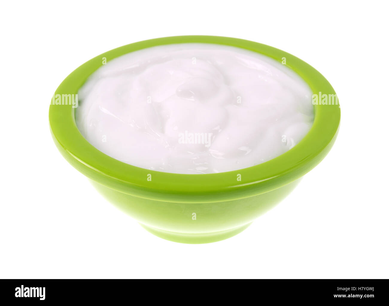 A small green bowl of vitamin E lotion isolated on a white background. Stock Photo