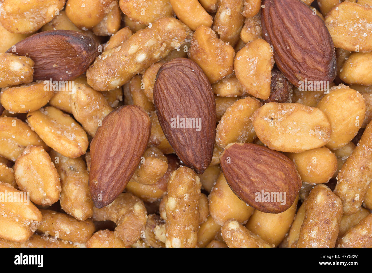 A very close view of an energy trail mix blend of peanuts, almonds and sesame sticks. Stock Photo