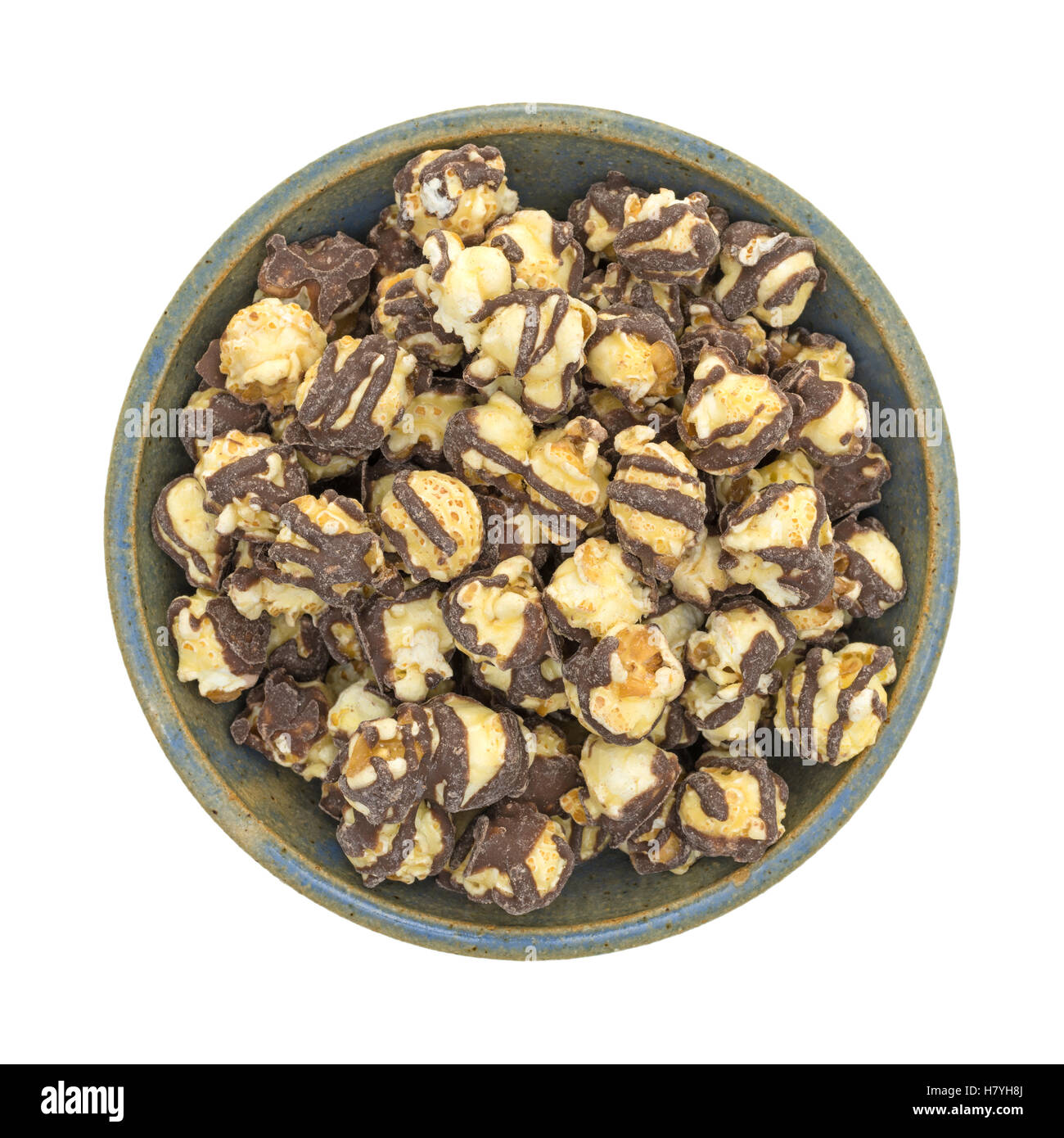 Top view of a serving of fudge drizzled popcorn in an old stoneware ...