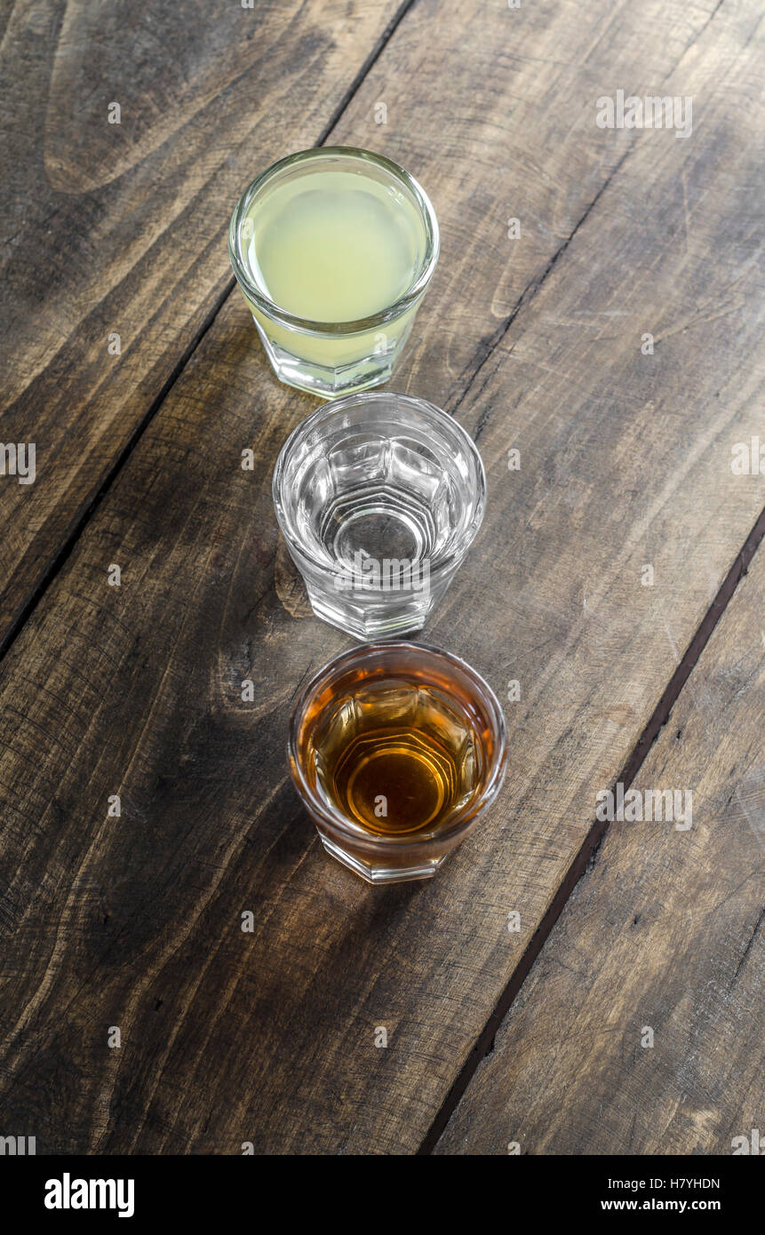 Glass of alcohol on wooden background close up Stock Photo