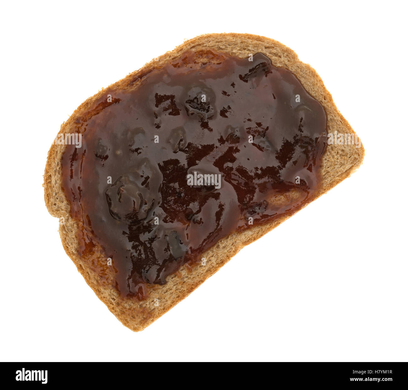 Top view of plum preserves spread on a piece of wheat bread isolated on a white background. Stock Photo