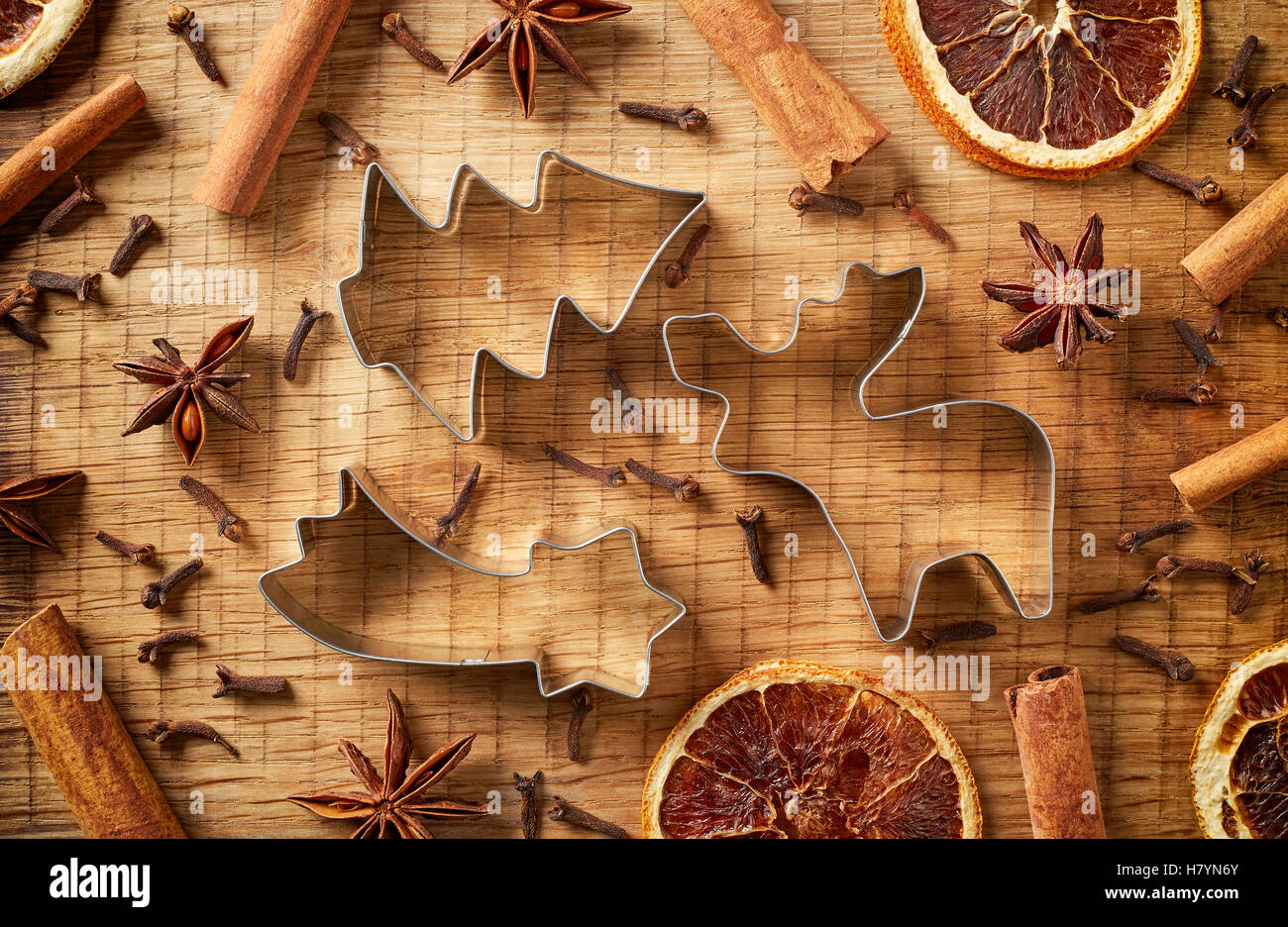 Christmas spices and cookie cutters on wooden background, top view Stock Photo