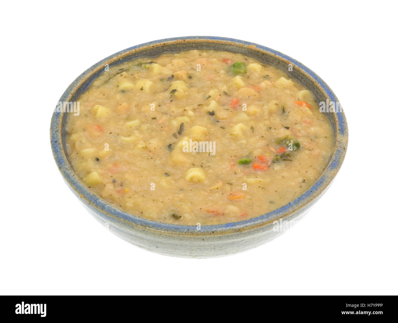A serving of white bean soup in an old stoneware bowl isolated on a white background. Stock Photo