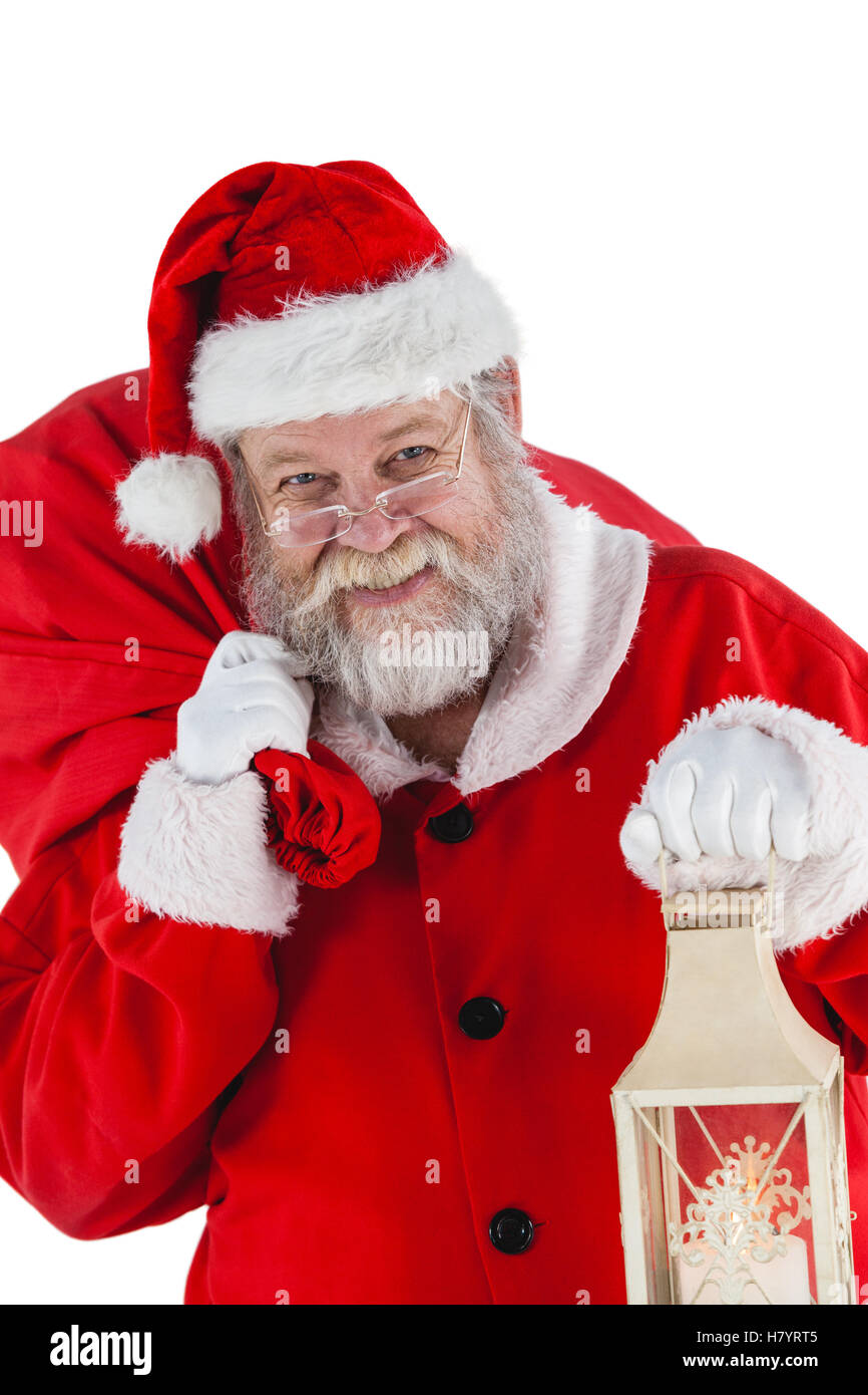 Portrait of santa claus holding christmas bag and lantern Stock Photo ...