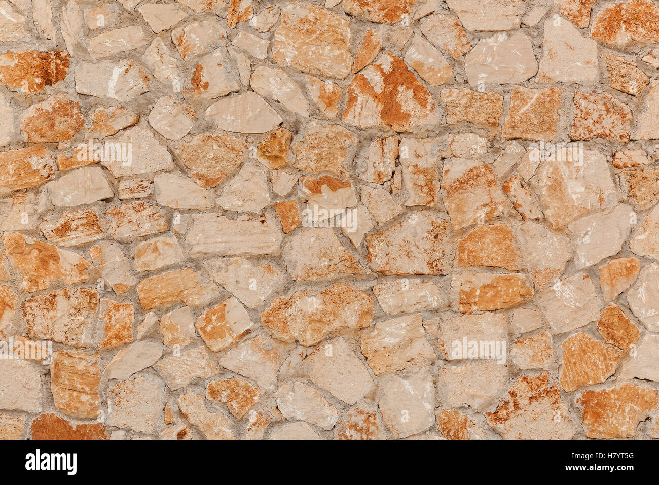 Concrete block. Outdoor yellow concrete blocks, stone wall texture