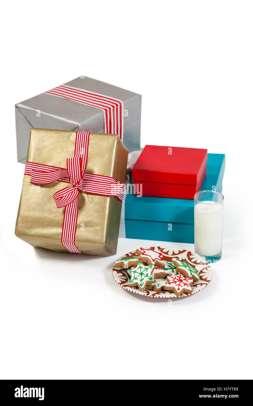 Close-up of milk and sweet food in plate with wrapped gift Stock Photo