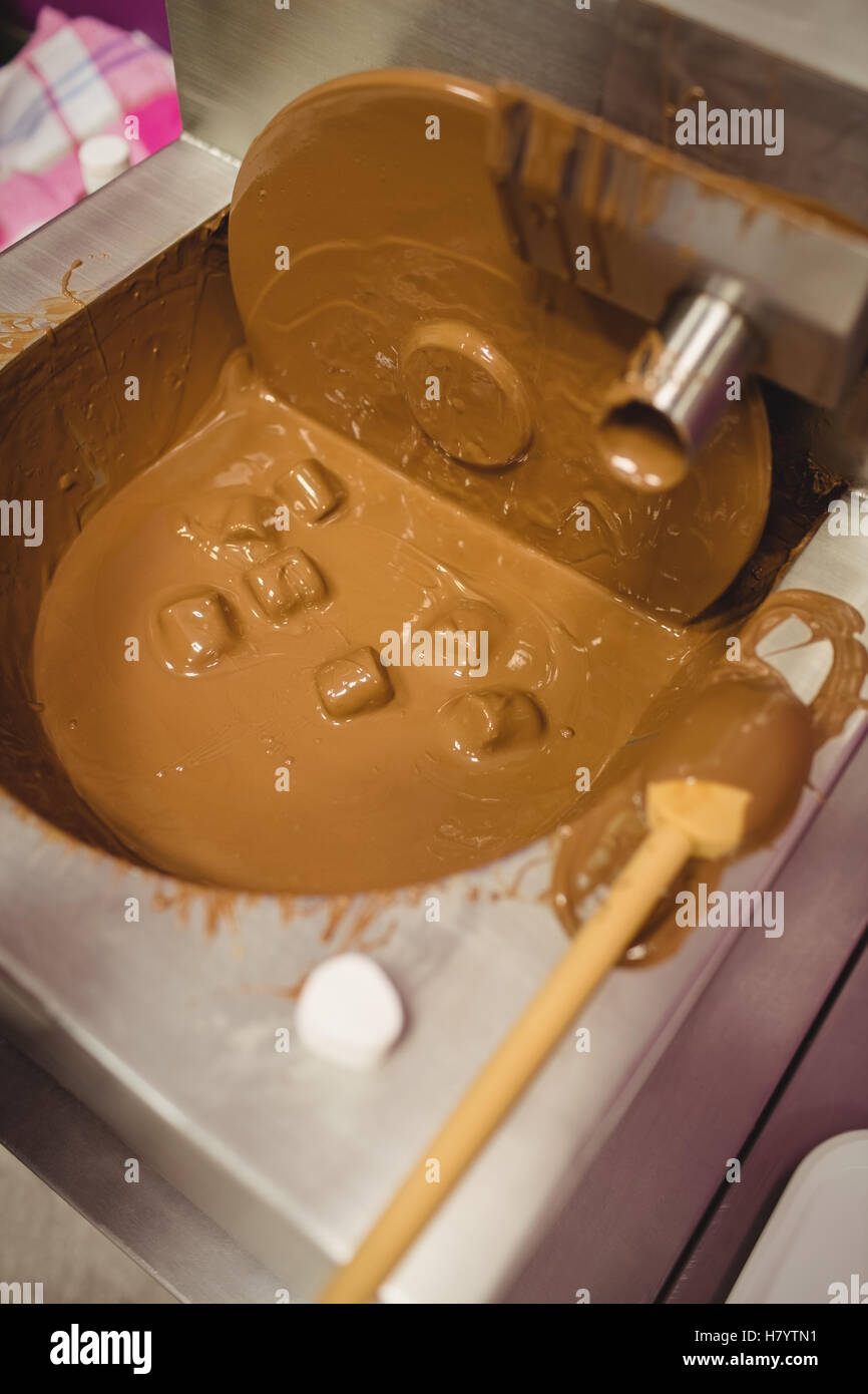 Close-up of marshmallow dipped in chocolate blending machine Stock Photo