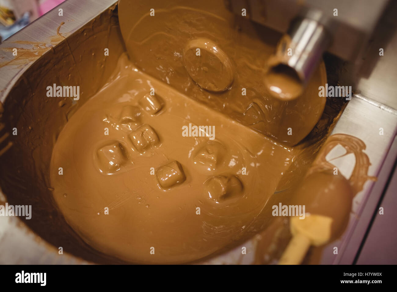 Close-up of marshmallow dipped in chocolate blending machine Stock Photo