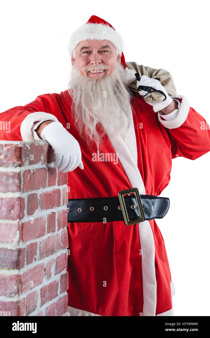 Portrait of santa claus carrying bag full of gifts Stock Photo - Alamy