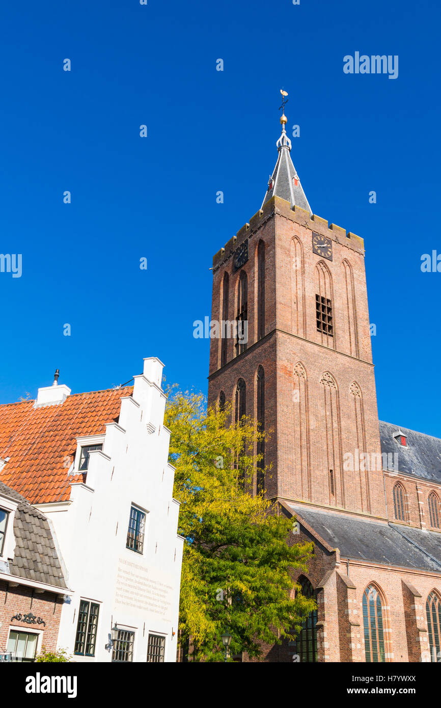 Tower of Big Church or Saint Vitus Church and stepped gable of old house in Naarden, North Holland, Netherlands Stock Photo