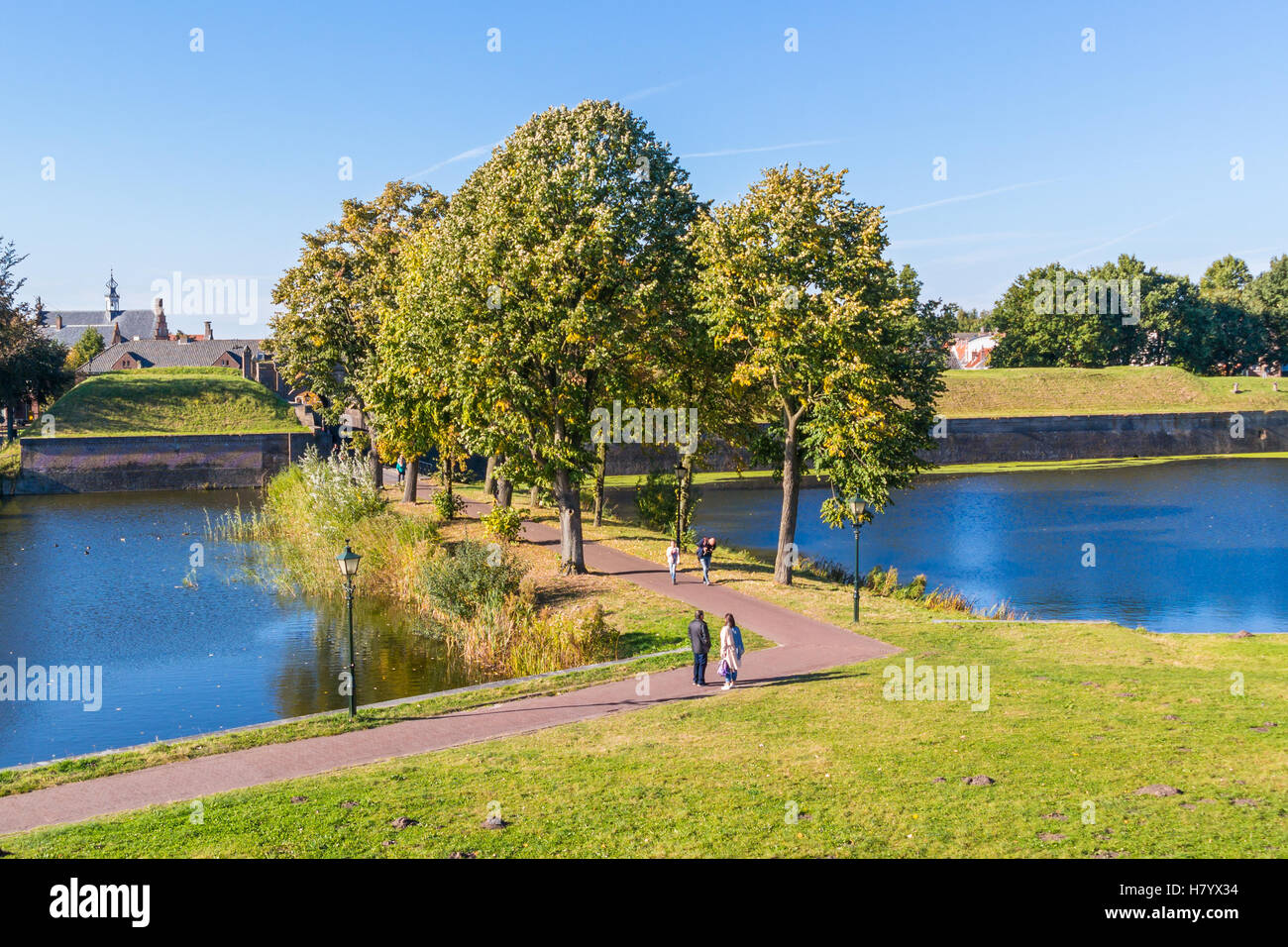 People walking and rampart of old fortified town of Naarden, North Holland, Netherlands Stock Photo