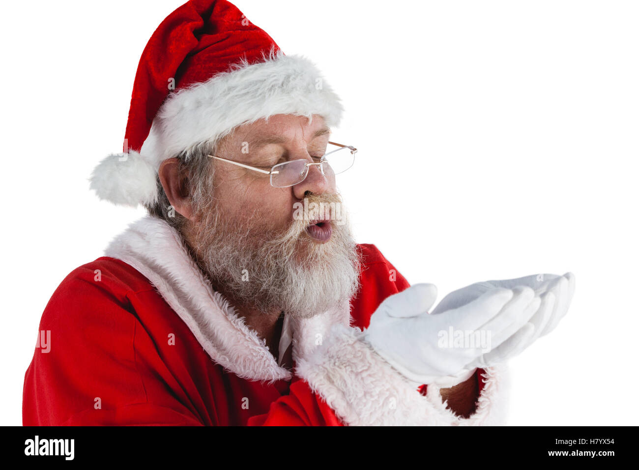Santa claus in eyeglasses blowing invisible snow Stock Photo