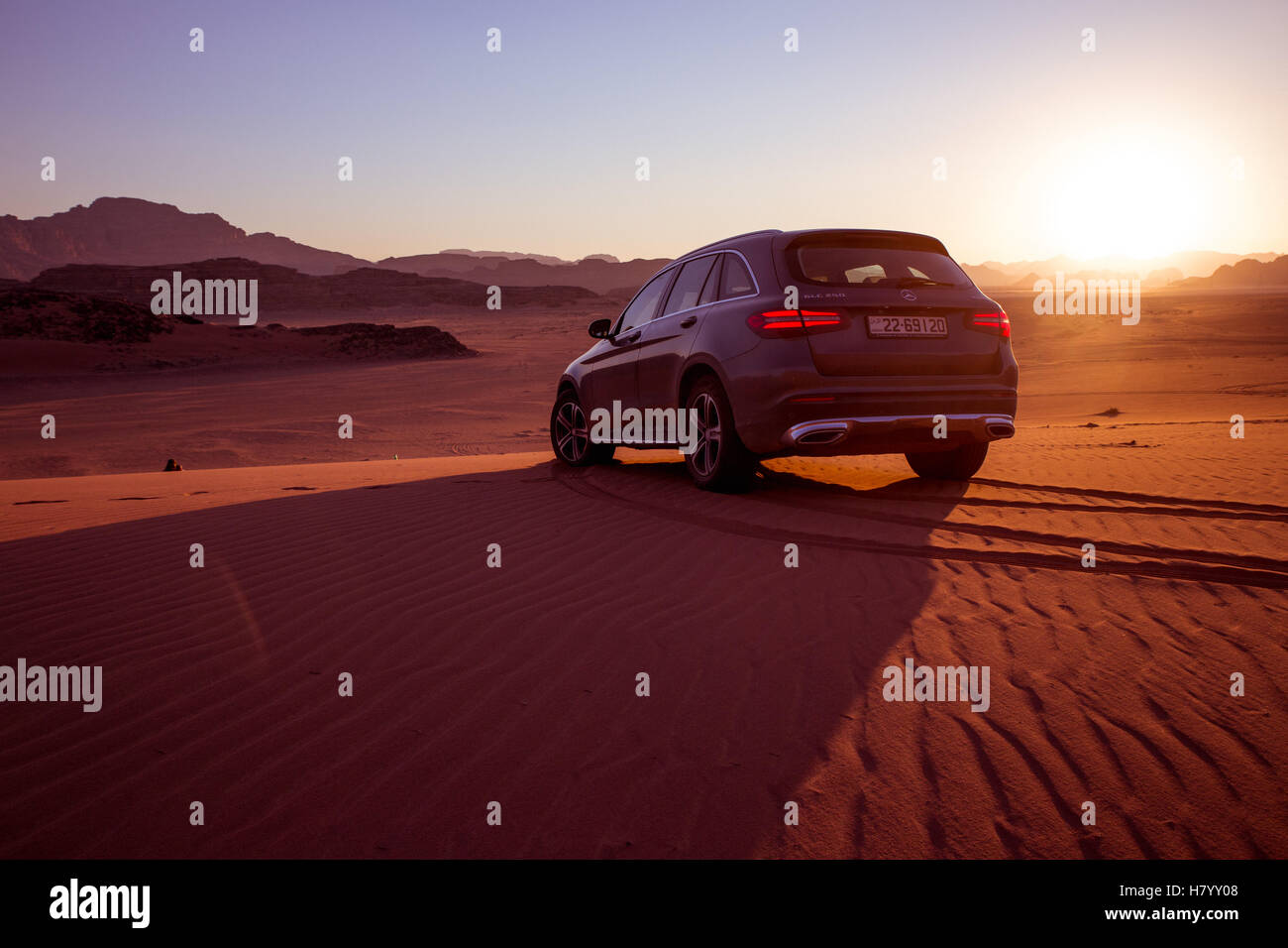 Mercedes Benz GLC250 SUV on dirt road, desert, sunset, Wadi Rum, Jordan Stock Photo