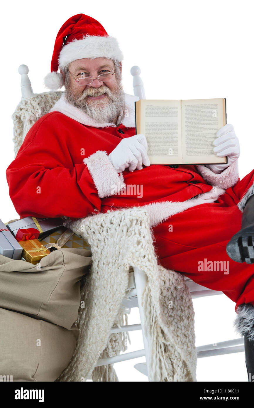 Happy santa claus showing bible Stock Photo Alamy