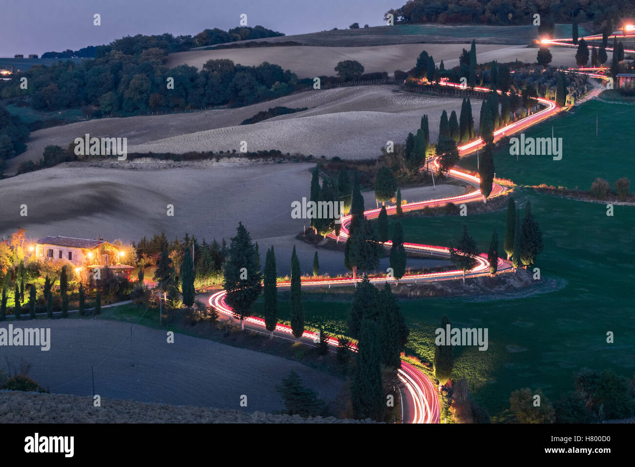 Evening landscapes of Tuscany with traces of car headlights Stock Photo