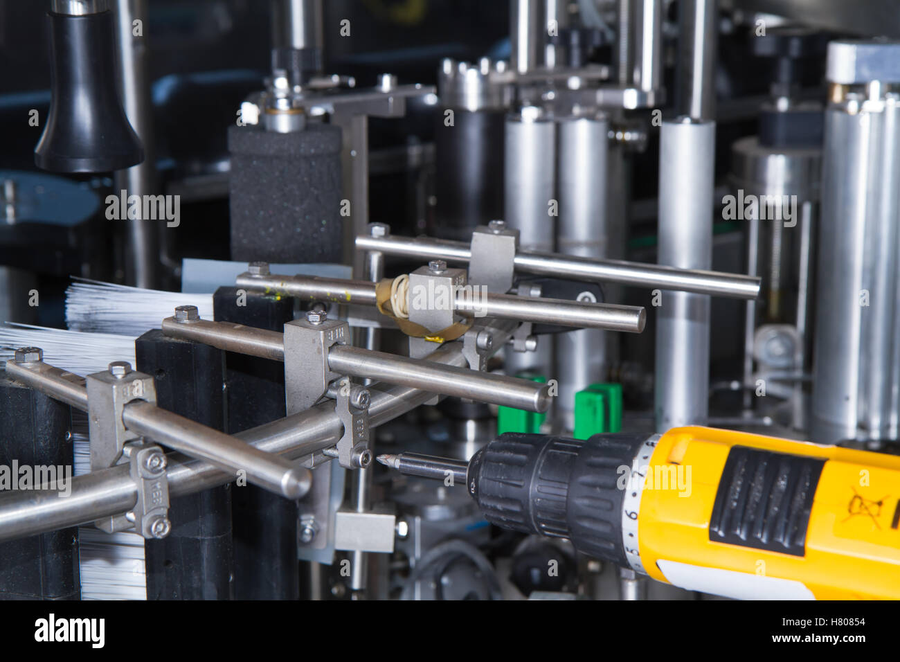 skilled worker while fixing a bottling plant during maintenance work Stock Photo Alamy