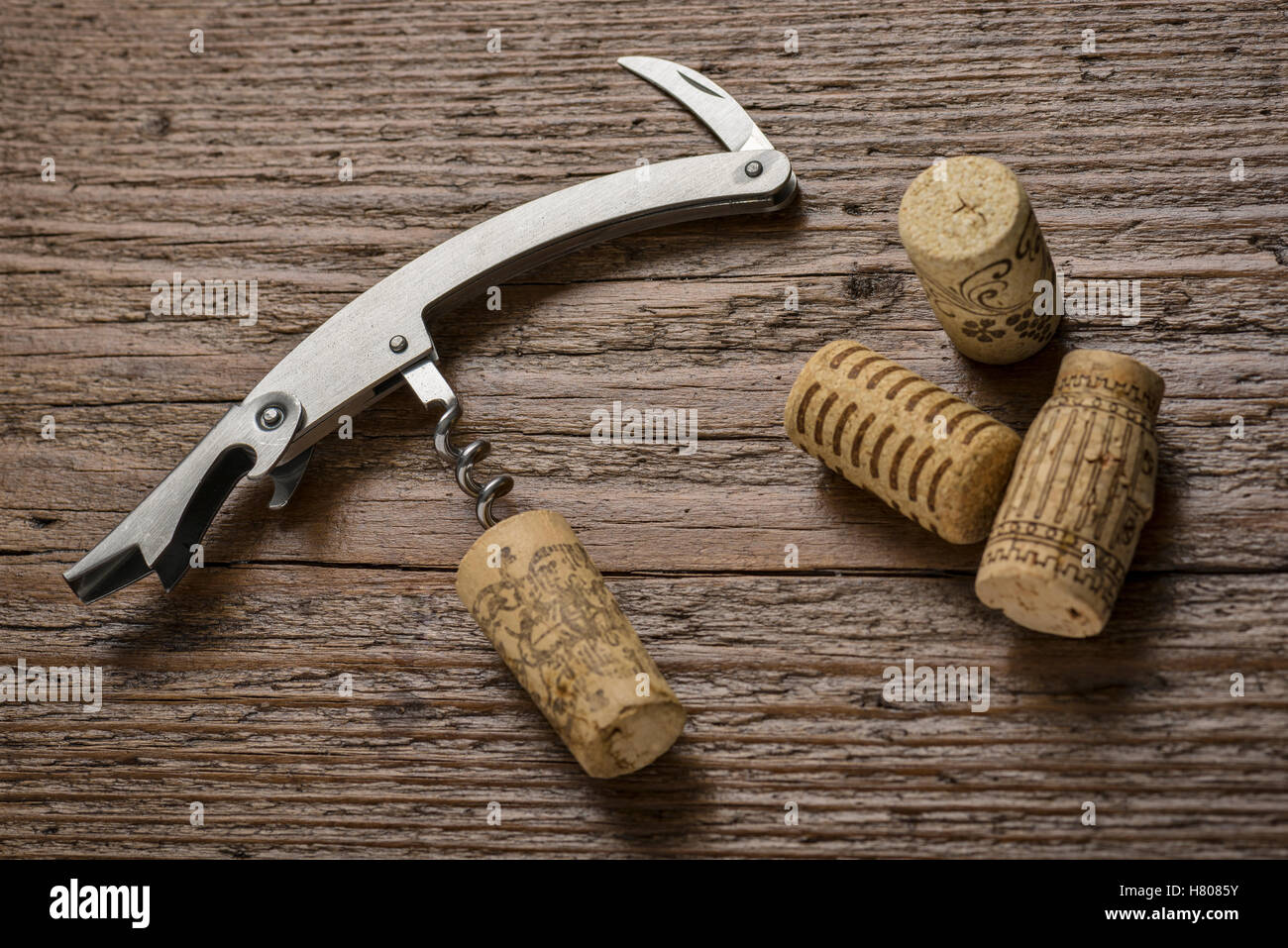 corkscrew with inserted cork on wooden table Stock Photo Alamy